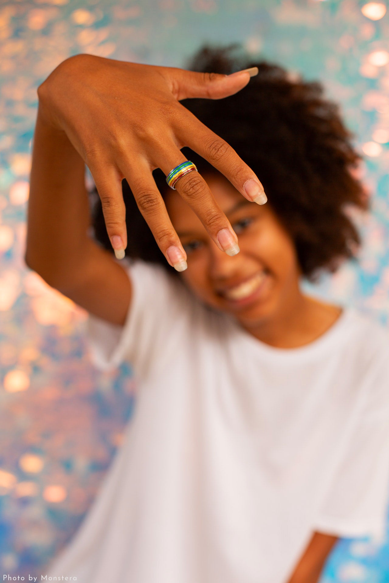 Woman showing hand with rainbow pride ring